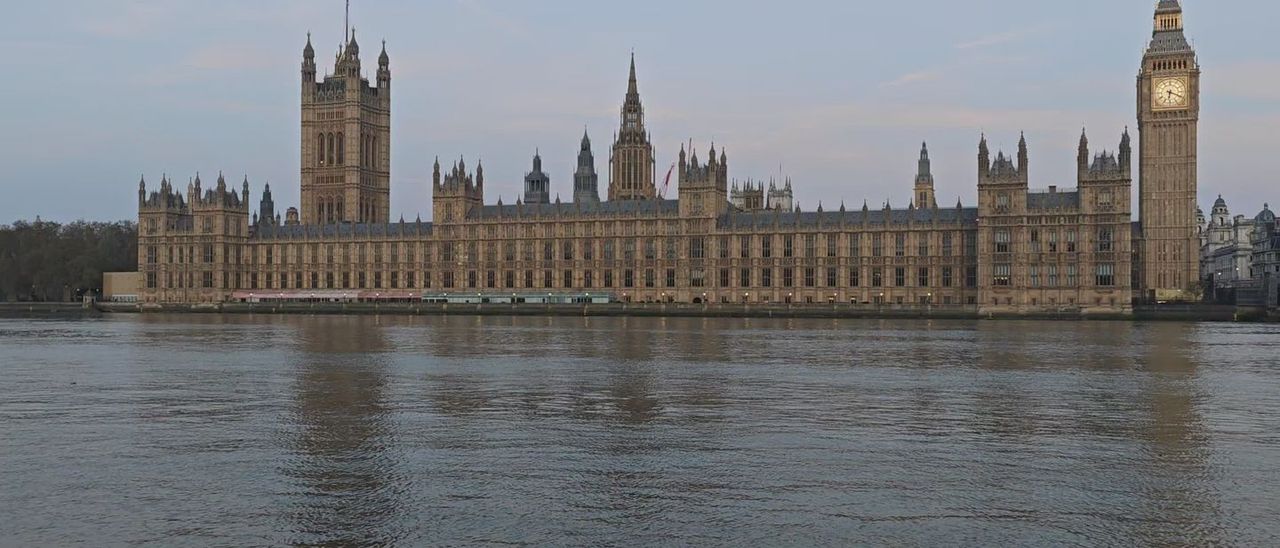 The Houses of Parliament beside the Thames at dusk